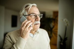 Older adult on a phone call learning how to spot and avoid Medicaid scam calls