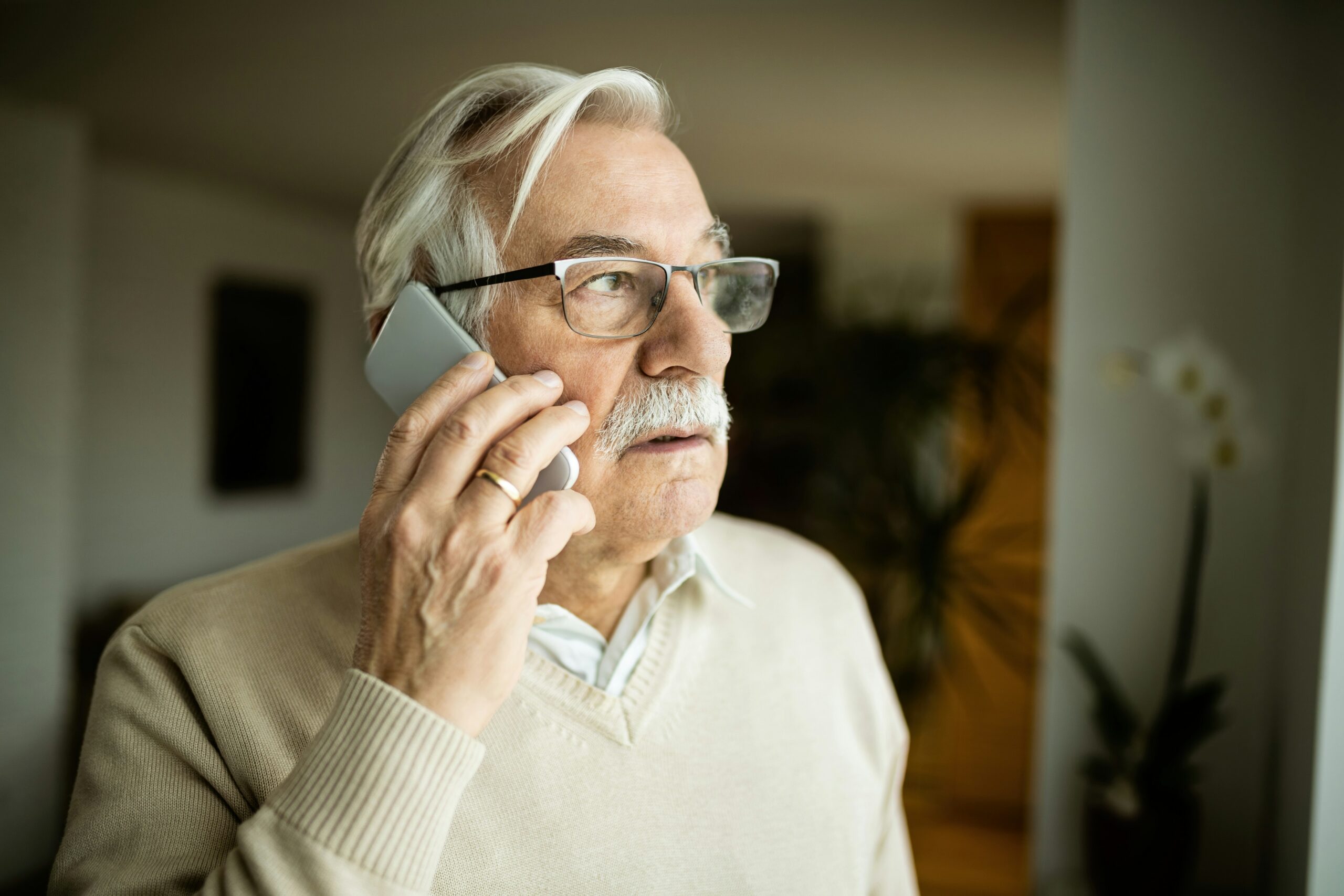 Older adult on a phone call learning how to spot and avoid Medicaid scam calls